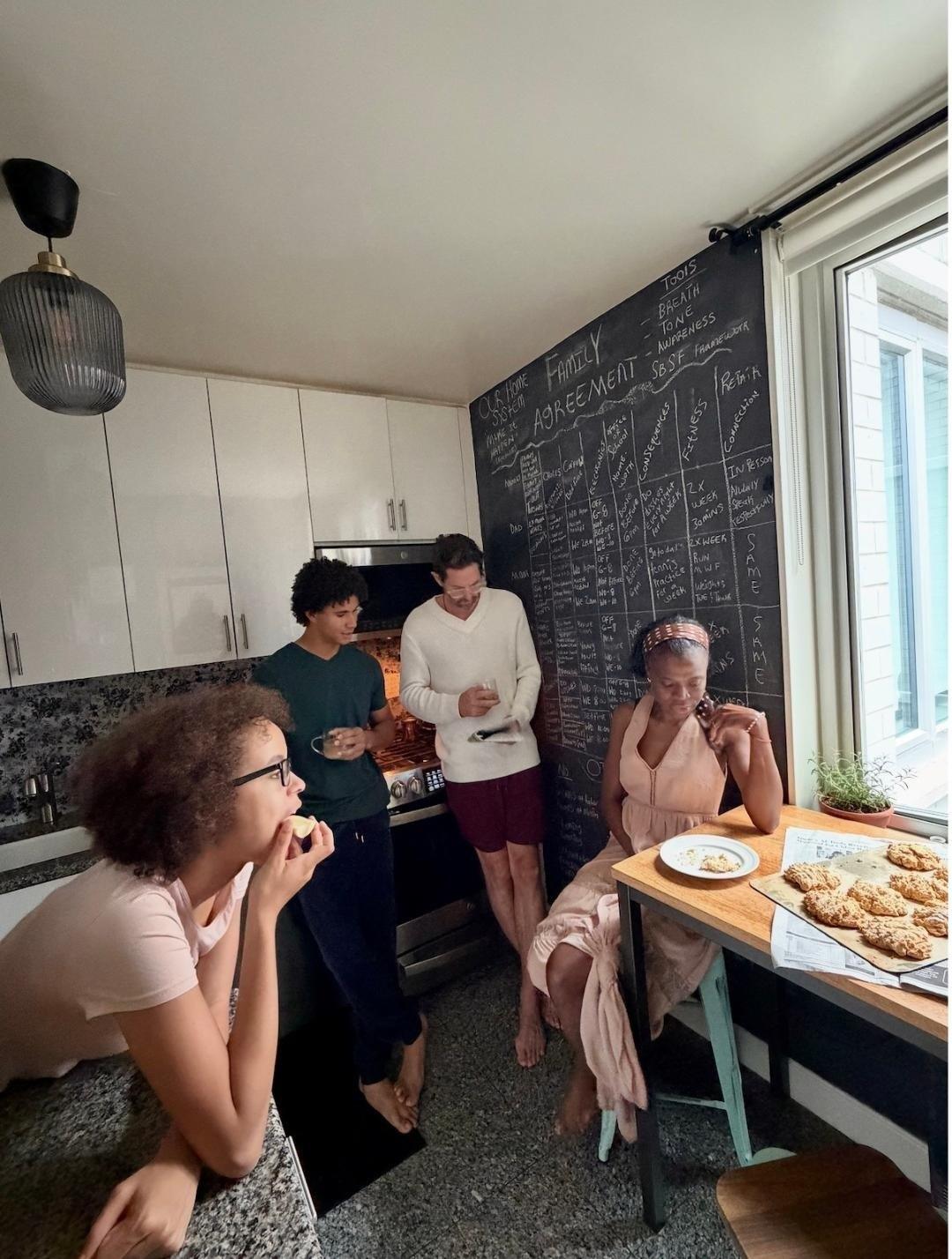 A family together in their kitchen, laughing
