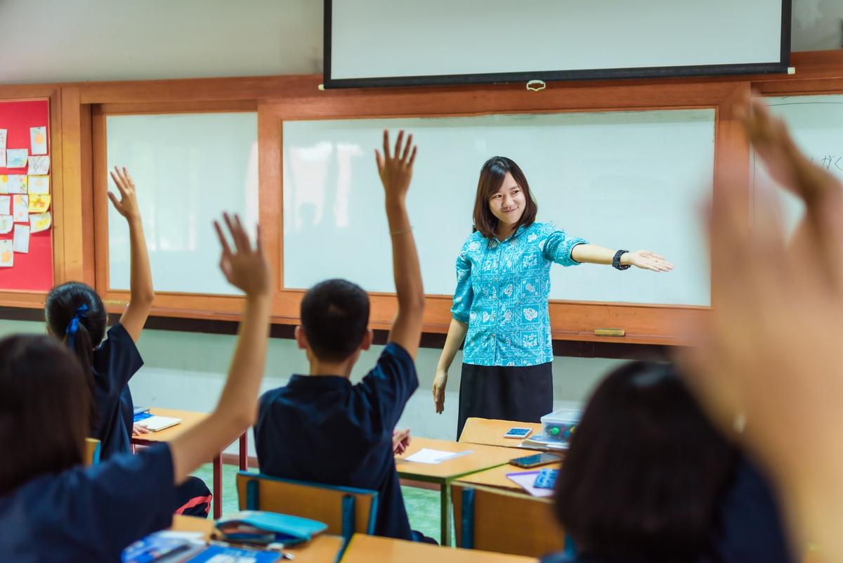 A student and teacher high-fiving